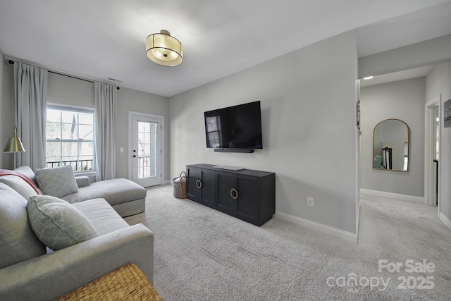 living area with baseboards and carpet