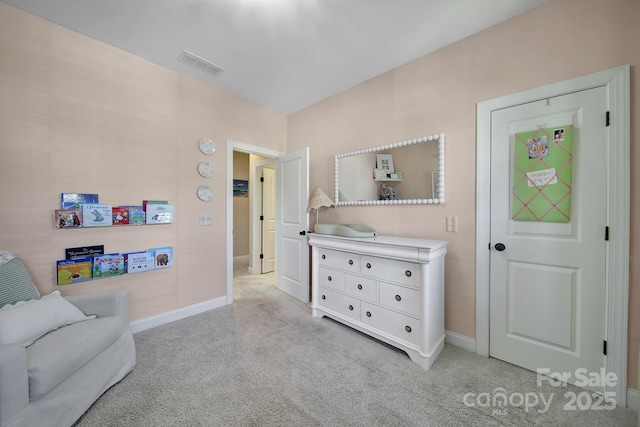 sitting room with visible vents, light carpet, and baseboards