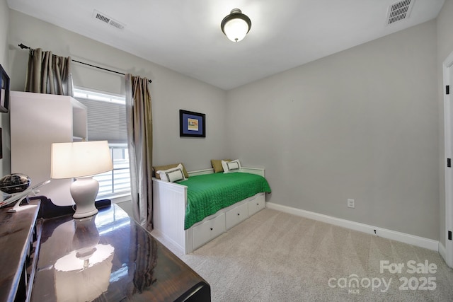 carpeted bedroom with visible vents and baseboards