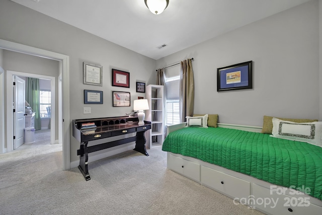 bedroom with visible vents, baseboards, and light colored carpet