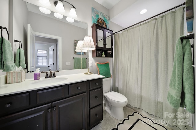 bathroom featuring a shower with curtain, toilet, vanity, and tile patterned flooring