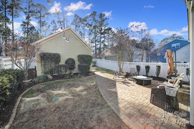 view of patio / terrace featuring a fire pit and a fenced backyard