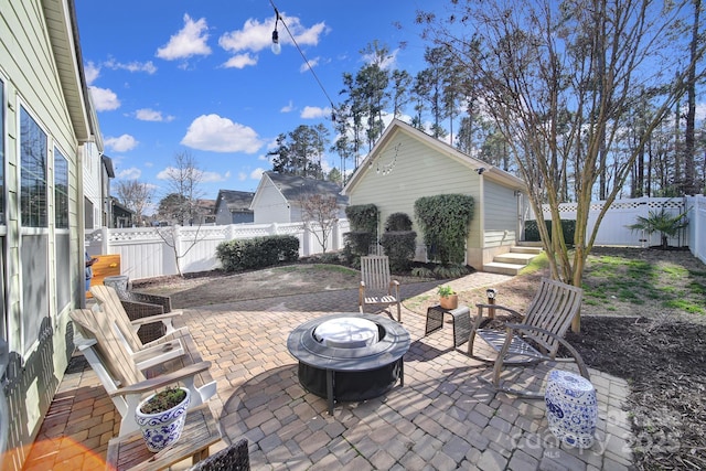 view of patio featuring an outbuilding, entry steps, and a fenced backyard