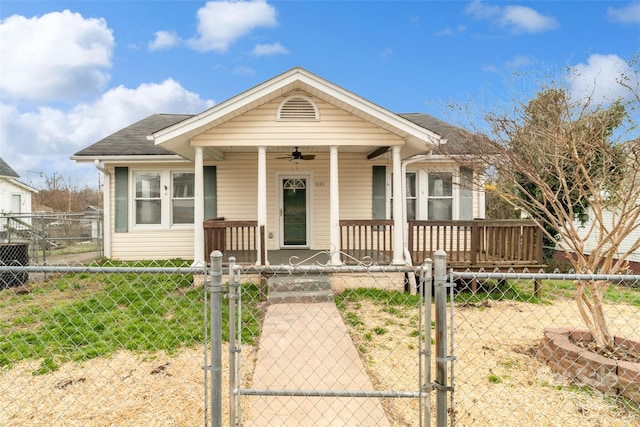 bungalow-style home featuring a ceiling fan, a gate, a fenced front yard, a porch, and roof with shingles