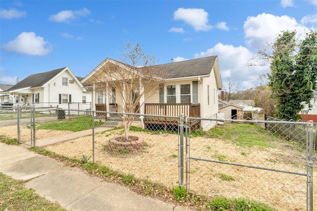 bungalow-style home with a gate and a fenced front yard