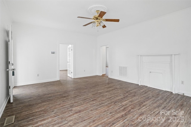 unfurnished living room featuring dark wood-type flooring, a ceiling fan, and visible vents