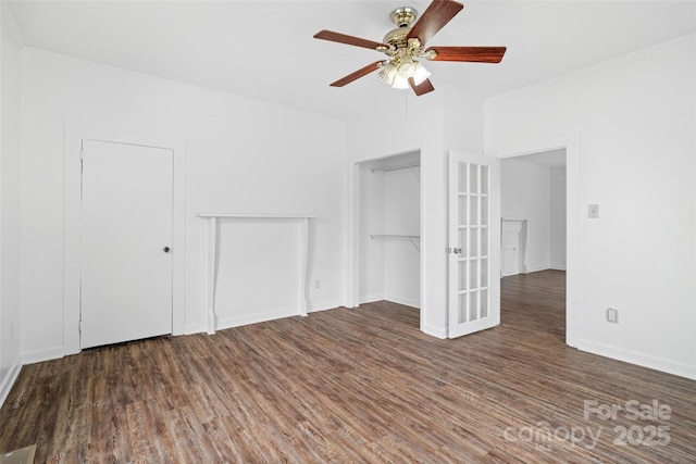 unfurnished room with wood finished floors, baseboards, and ceiling fan