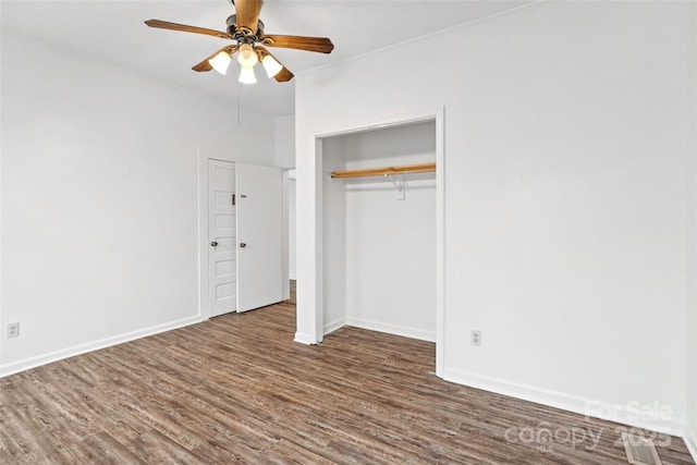 unfurnished bedroom with a closet, ceiling fan, baseboards, and wood finished floors