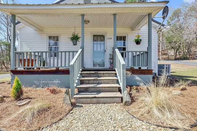 view of front facade featuring cooling unit and a porch