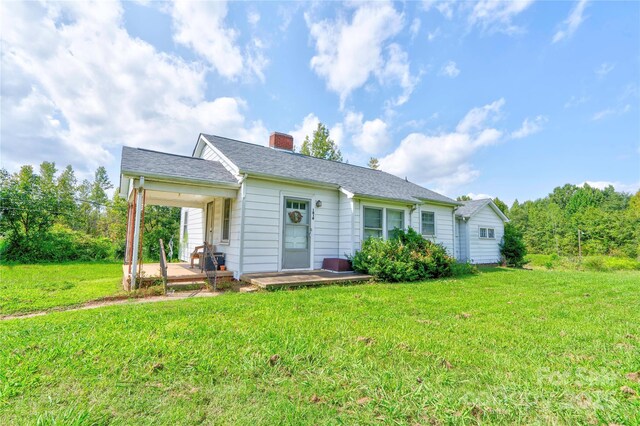1414 S Post Rd, Shelby, NC 28152 - view of front of home with roof with shingles, an attached carport, a chimney, and a front yard