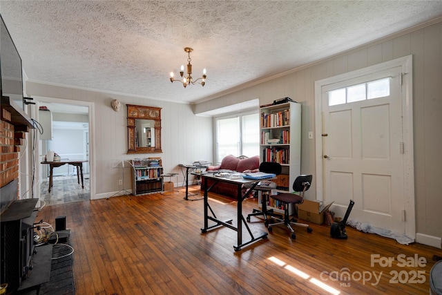 1414 S Post Rd, Shelby, NC 28152 - office space with a textured ceiling, hardwood / wood-style flooring, an inviting chandelier, a wood stove, and crown molding