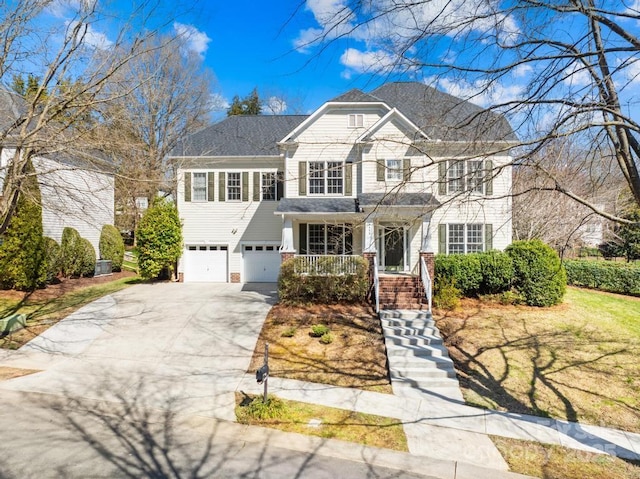 view of front of house featuring driveway, a porch, and an attached garage