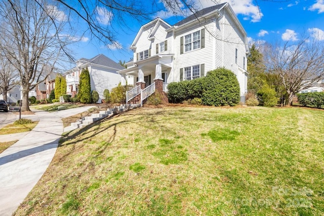 view of front of home with covered porch and a front yard