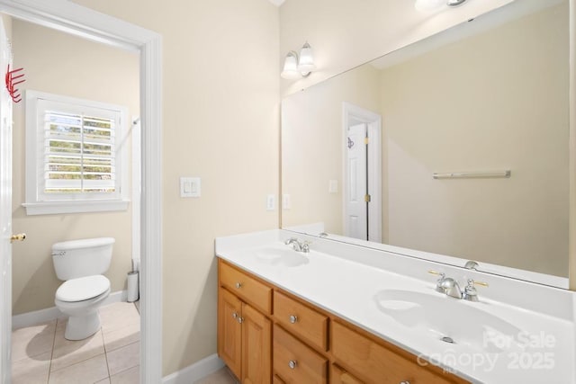 full bathroom featuring tile patterned flooring, double vanity, toilet, and a sink