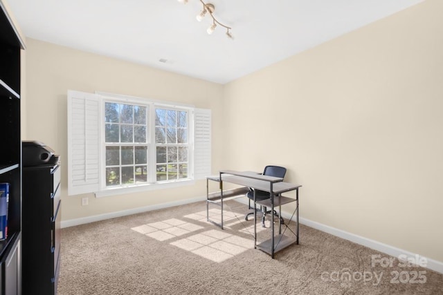 office featuring rail lighting, baseboards, and carpet floors