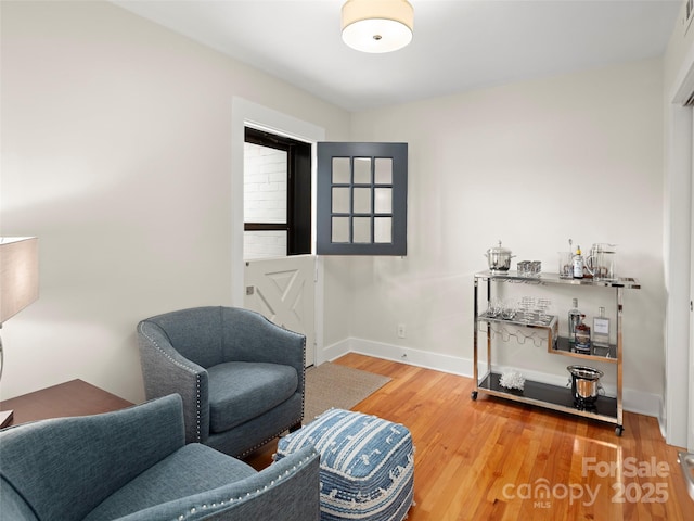 living area with wood finished floors and baseboards