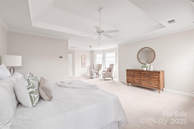 bedroom featuring a tray ceiling, carpet flooring, crown molding, and visible vents