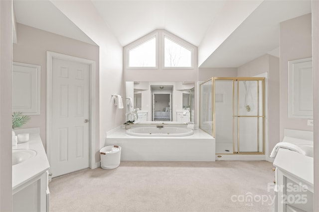 bathroom with a garden tub, a stall shower, vanity, and lofted ceiling