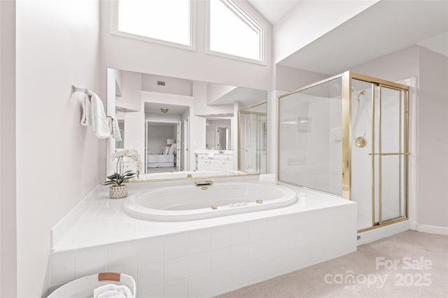 full bath with visible vents, a shower stall, a high ceiling, and a garden tub