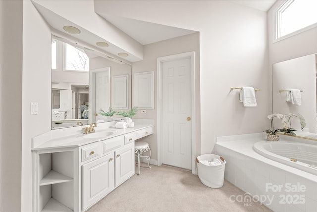 full bathroom featuring vanity and a garden tub