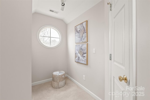 living area featuring vaulted ceiling, visible vents, baseboards, and carpet floors