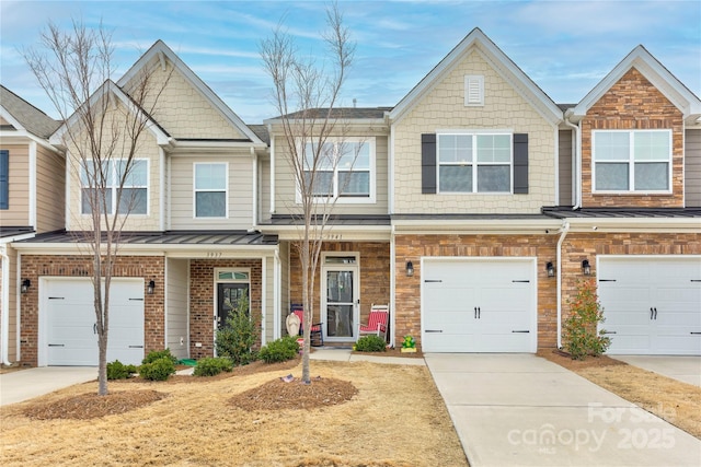 townhome / multi-family property featuring brick siding, concrete driveway, a standing seam roof, and metal roof