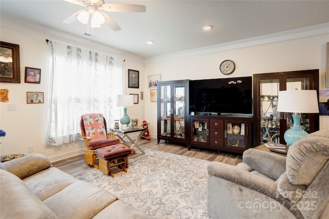 living room with ceiling fan, baseboards, wood finished floors, and ornamental molding