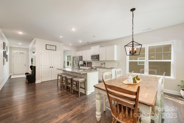 9428 Segundo Ln, Charlotte, NC 28278 - dining space with recessed lighting, baseboards, dark wood-style floors, and a notable chandelier