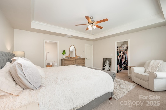 9428 Segundo Ln, Charlotte, NC 28278 - bedroom with a walk in closet, ornamental molding, a tray ceiling, and light colored carpet