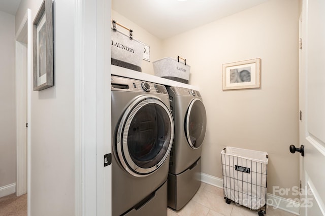 9428 Segundo Ln, Charlotte, NC 28278 - laundry area with light tile patterned flooring, baseboards, washer and dryer, and laundry area