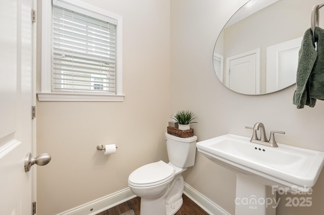 9428 Segundo Ln, Charlotte, NC 28278 - half bath with wood finished floors, baseboards, a sink, and toilet
