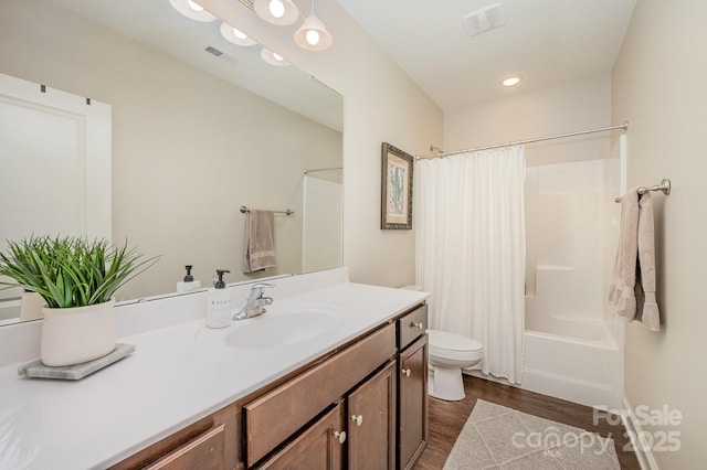 9428 Segundo Ln, Charlotte, NC 28278 - bathroom featuring wood finished floors, vanity, visible vents, toilet, and shower / bath combo with shower curtain