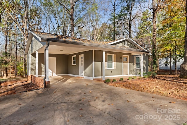 view of front of home featuring an attached carport and driveway