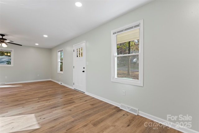 entrance foyer with visible vents, recessed lighting, plenty of natural light, and wood finished floors