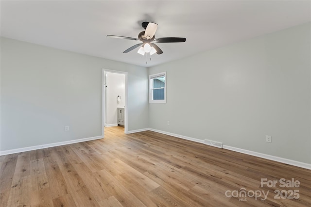 unfurnished room with visible vents, ceiling fan, light wood-type flooring, and baseboards