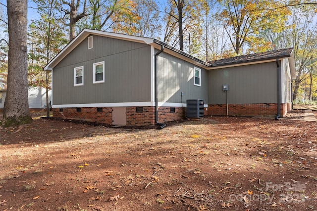 view of property exterior with crawl space and central air condition unit