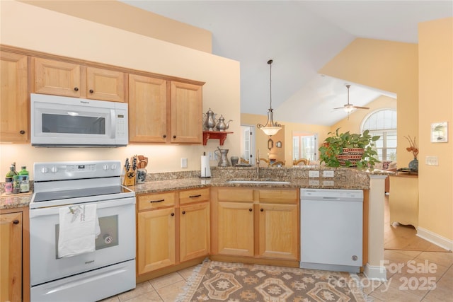 kitchen with vaulted ceiling, a peninsula, light tile patterned flooring, white appliances, and a sink