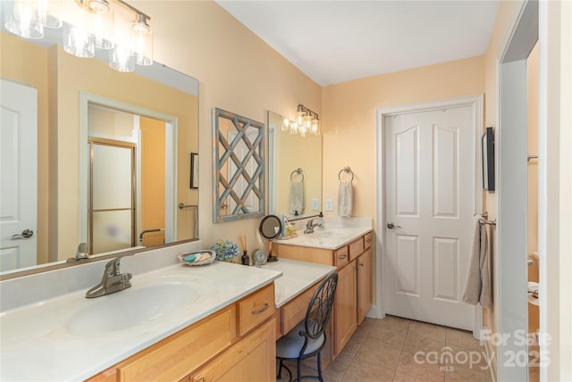 full bath with tile patterned flooring, a stall shower, and vanity