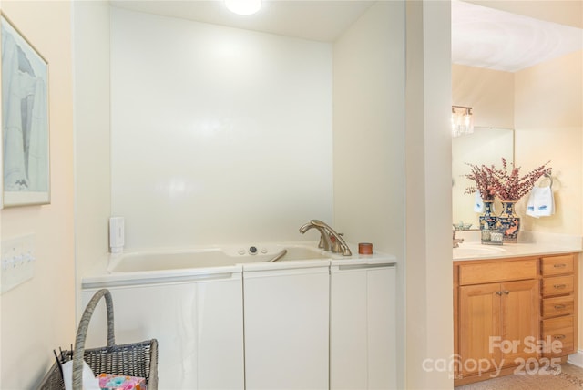 bathroom featuring vanity and a whirlpool tub