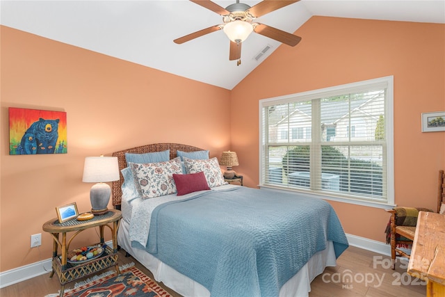 bedroom featuring lofted ceiling, wood finished floors, visible vents, and baseboards