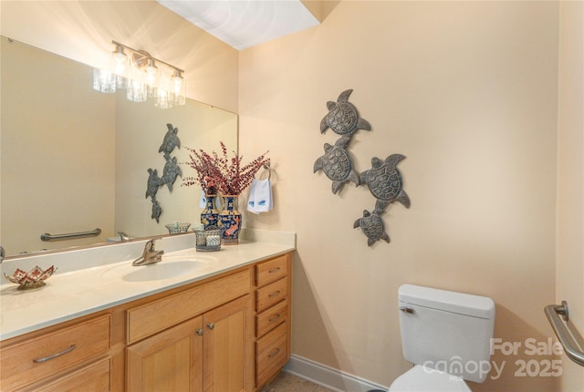 bathroom with toilet and vanity