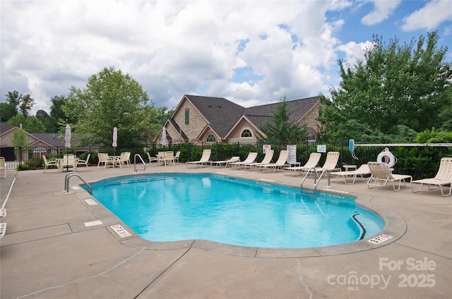 view of pool featuring a patio and fence