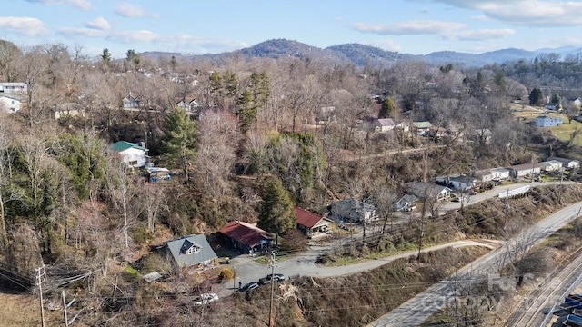 bird's eye view with a mountain view and a wooded view