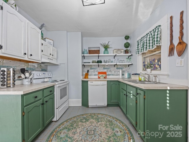 kitchen featuring white appliances, light countertops, green cabinetry, and a sink