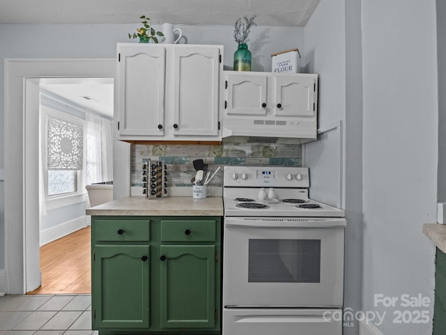 kitchen featuring electric range, under cabinet range hood, green cabinets, white cabinets, and light countertops