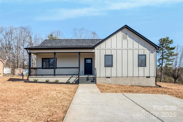 view of front facade with crawl space, covered porch, board and batten siding, and a shingled roof