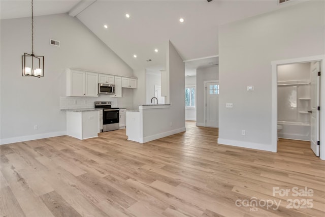 kitchen featuring visible vents, appliances with stainless steel finishes, light wood-type flooring, and open floor plan