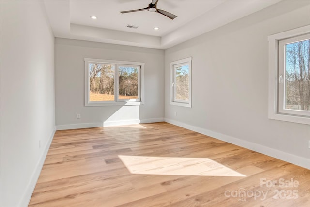 spare room with visible vents, baseboards, and light wood-type flooring