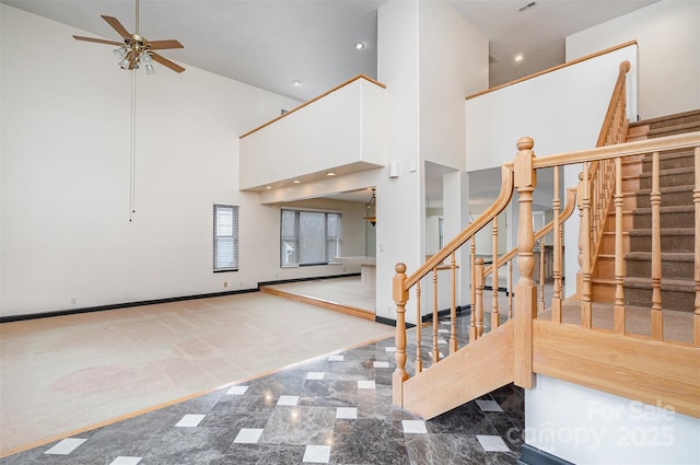 interior space with recessed lighting, carpet floors, a high ceiling, baseboards, and ceiling fan