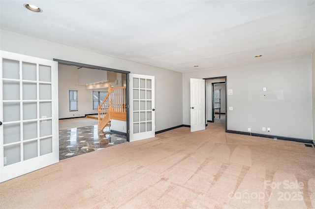 carpeted spare room with stairway, recessed lighting, visible vents, and baseboards